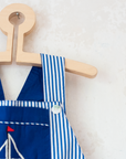 Overalls with blue stripes and an embroidered sailboat | 18-24 months