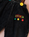 מכנסי שלייקס שחורים עם כפתורים צבעוניים | 18-24 חודשים