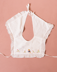 White bib with girl embroidery and flowers | 0-6 months