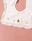White bib with girl embroidery and flowers | 0-6 months