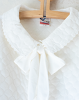 White quilted jacket with large bow tie | 6-7 years