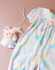 Pastel colored overalls with tree print and doll on a string | 18-24 months