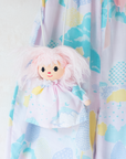 Pastel colored overalls with tree print and doll on a string | 18-24 months