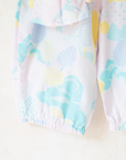 Pastel colored overalls with tree print and doll on a string | 18-24 months