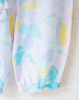Pastel colored overalls with tree print and doll on a string | 18-24 months