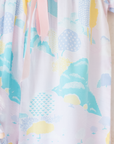 Pastel colored overalls with tree print and doll on a string | 18-24 months