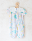 Pastel colored overalls with tree print and doll on a string | 18-24 months