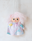 Pastel colored overalls with tree print and doll on a string | 18-24 months