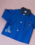 Blue shirt with embroidery of a boy riding a bicycle | French dead stock from the seventies | 8-9 years
