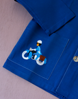 Blue shirt with embroidery of a boy riding a bicycle | French dead stock from the seventies | 7-8 years
