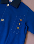 Blue shirt with embroidery of a boy riding a bicycle | French dead stock from the seventies | 8-9 years