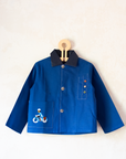 Blue shirt with embroidery of a boy riding a bicycle | French dead stock from the seventies | 7-8 years