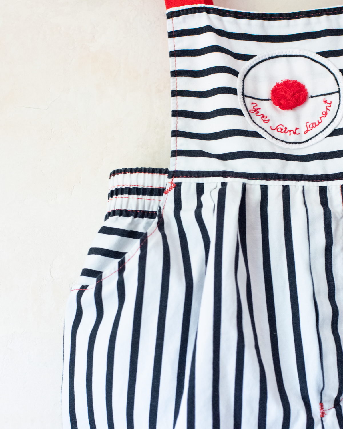 Striped overalls with red pom-pom from Yves Saint Laurent | 12-18 months