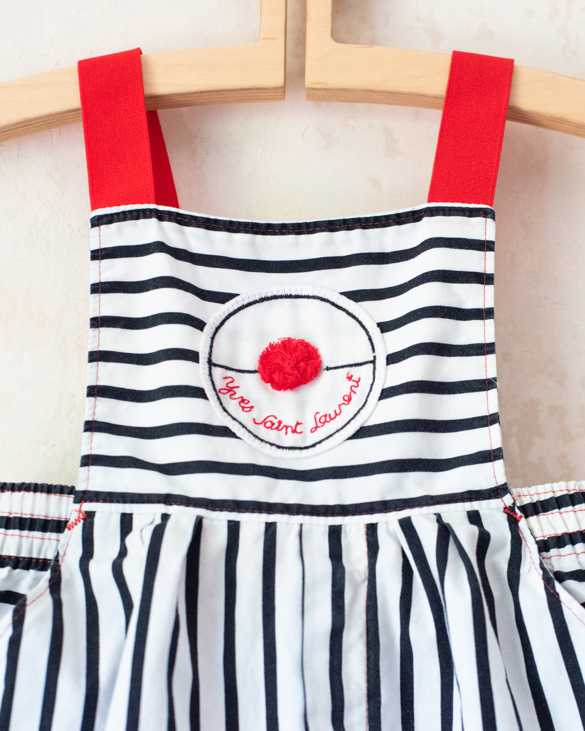Striped overalls with red pom-pom from Yves Saint Laurent | 12-18 months