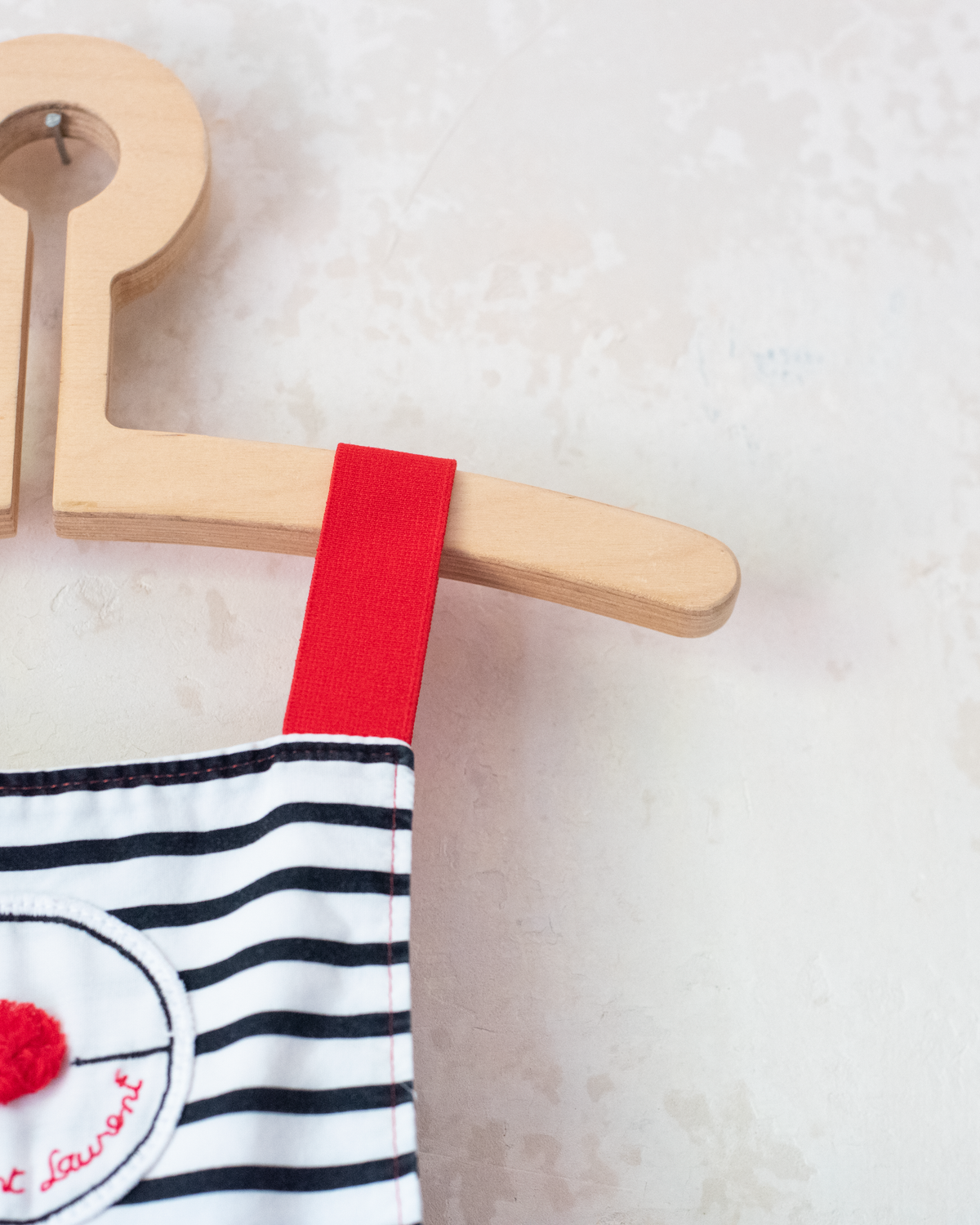 Striped overalls with red pom-pom from Yves Saint Laurent | 12-18 months