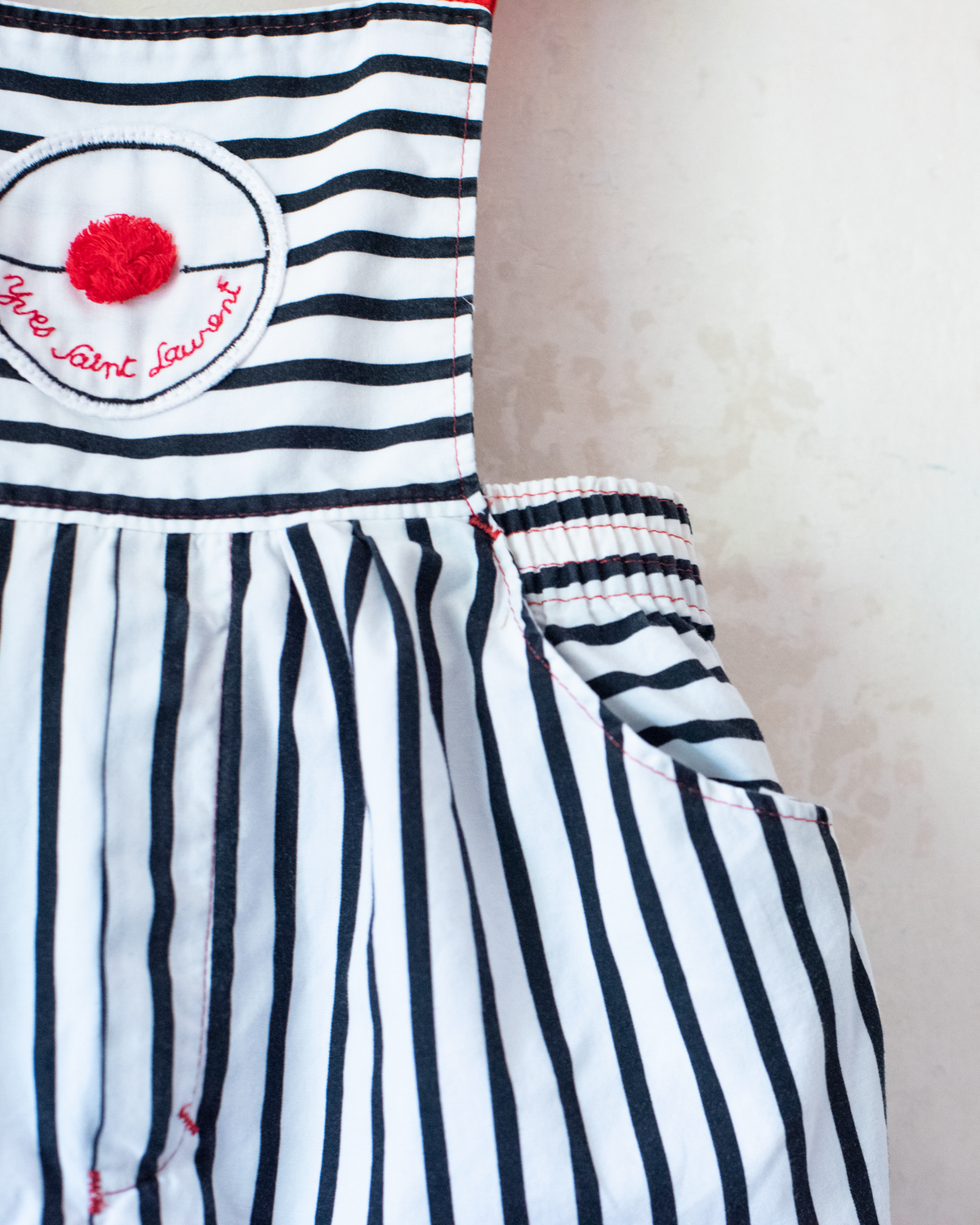 Striped overalls with red pom-pom from Yves Saint Laurent | 12-18 months