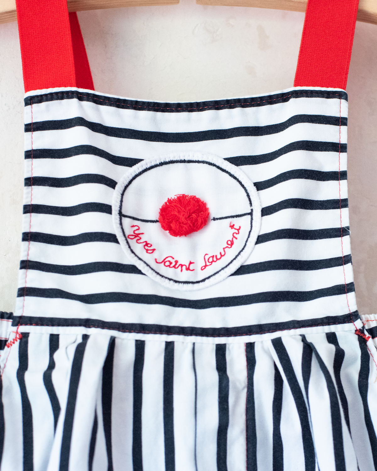 Striped overalls with red pom-pom from Yves Saint Laurent | 12-18 months