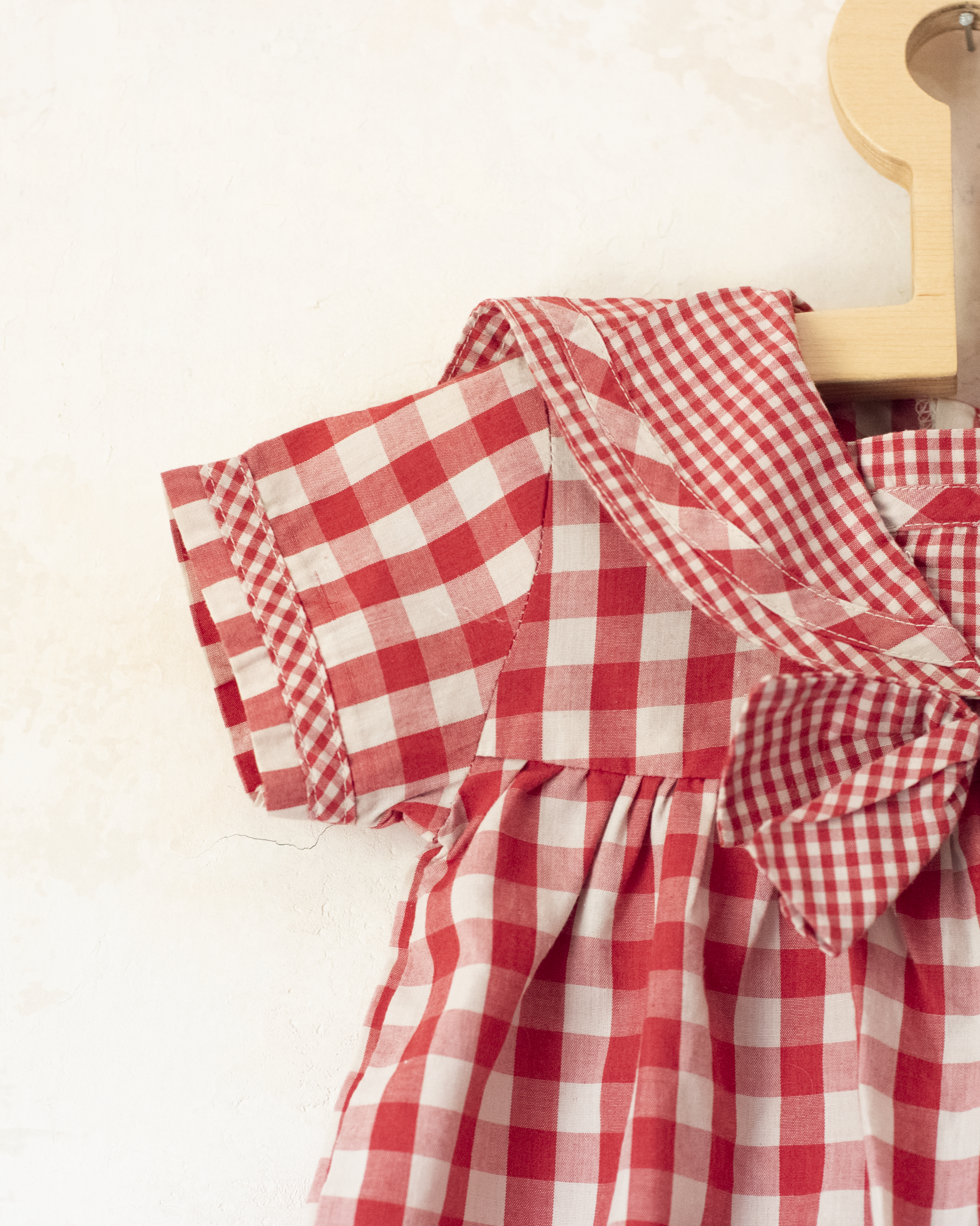 Red plaid romper with bow | 9-12 months