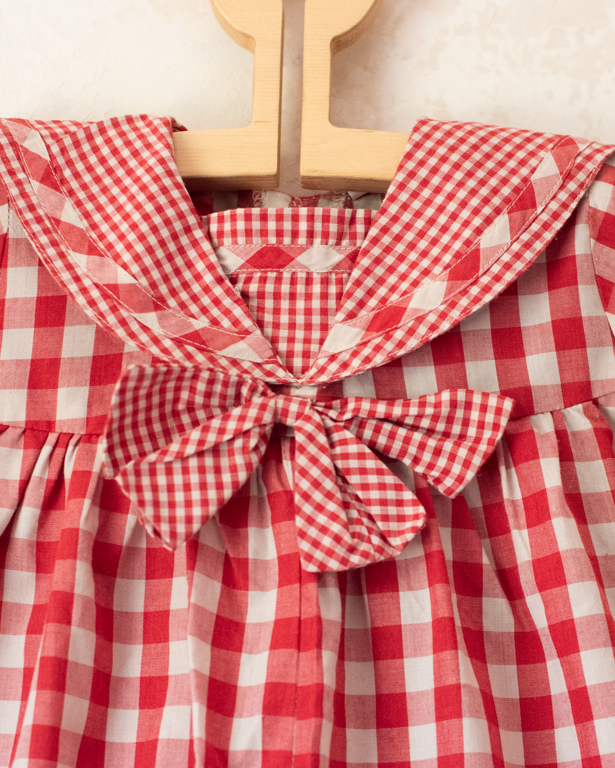 Red plaid romper with bow | 9-12 months