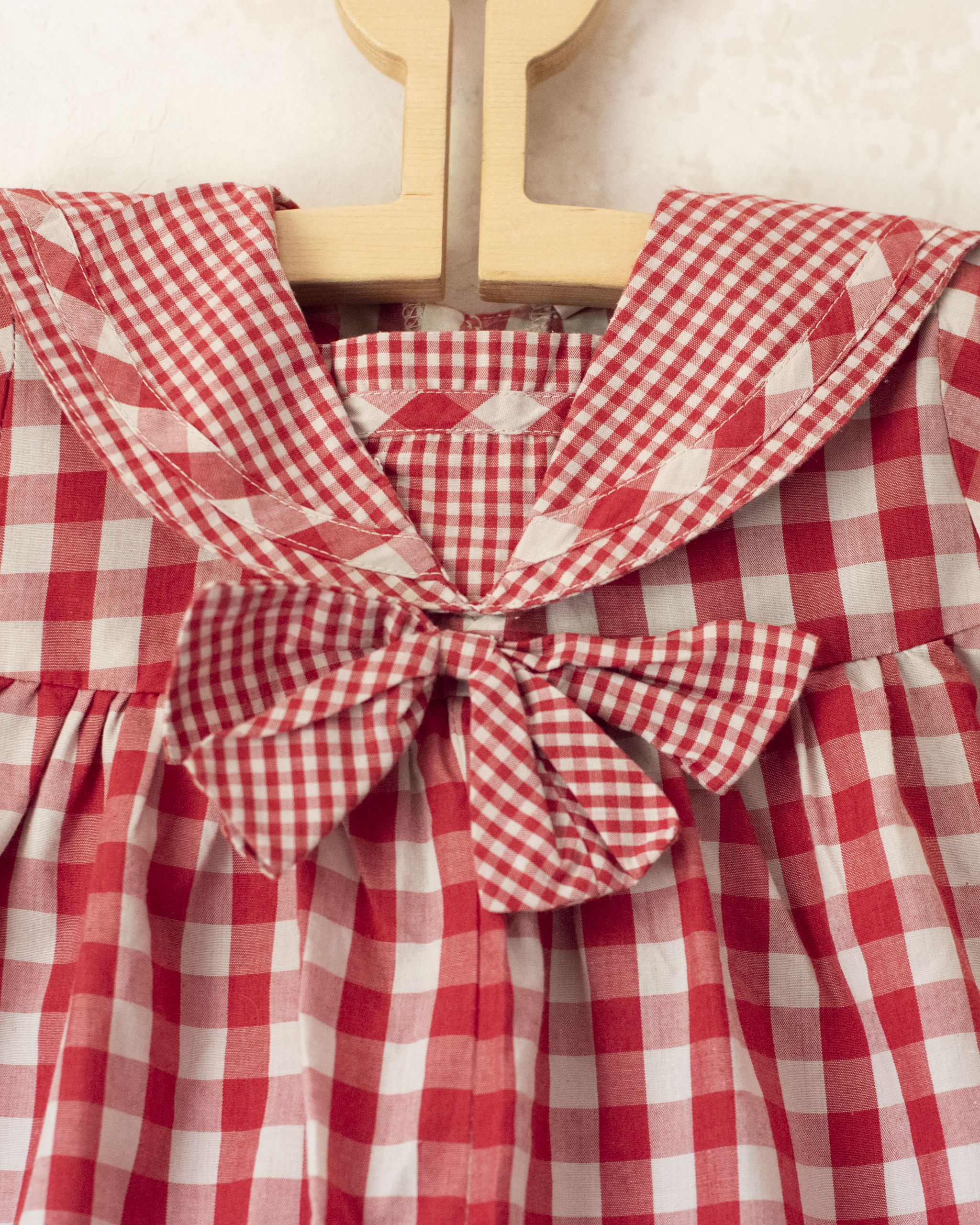 Red plaid romper with bow | 9-12 months
