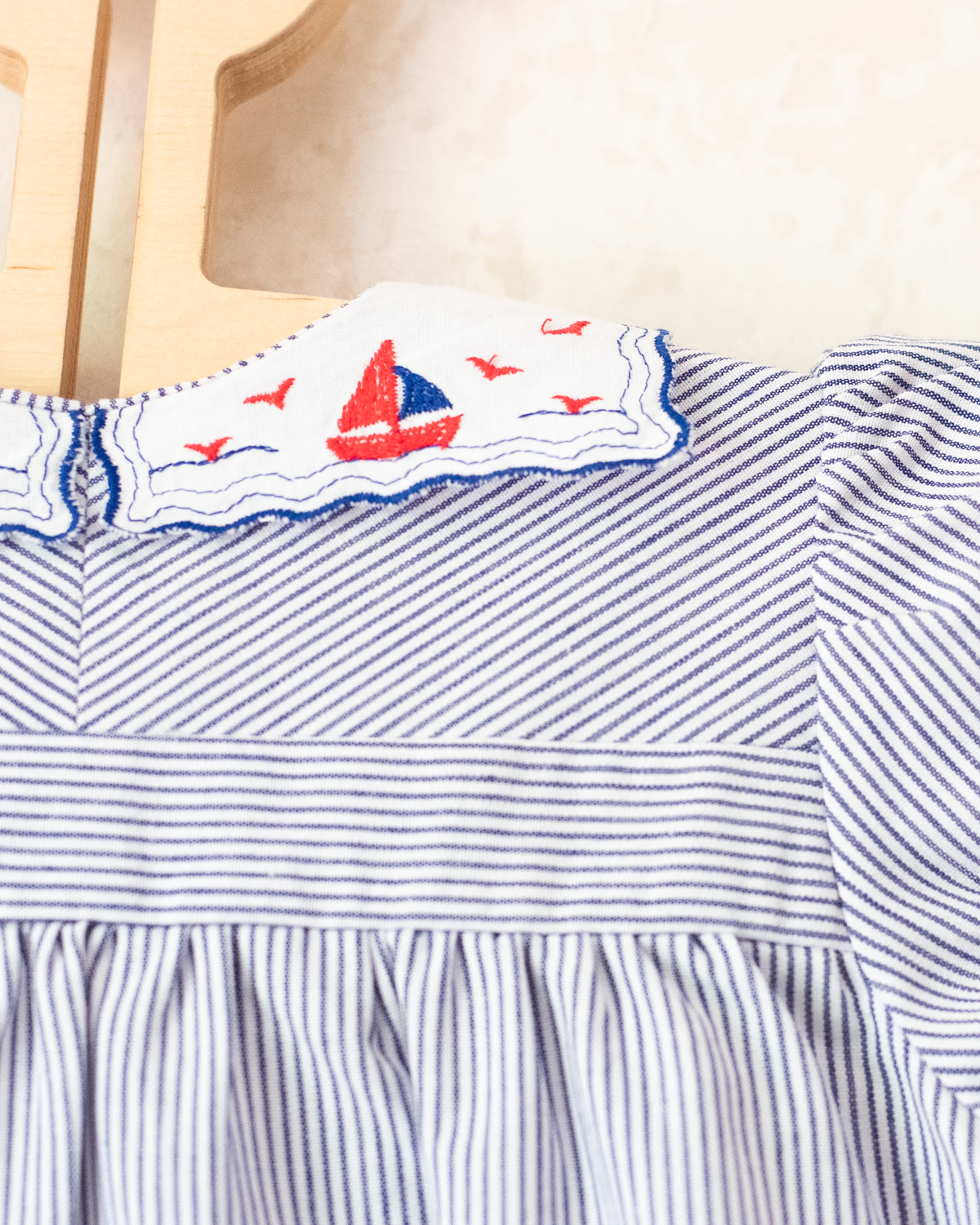 Striped dress with sailboats embroidered on the collar | 9-12 months