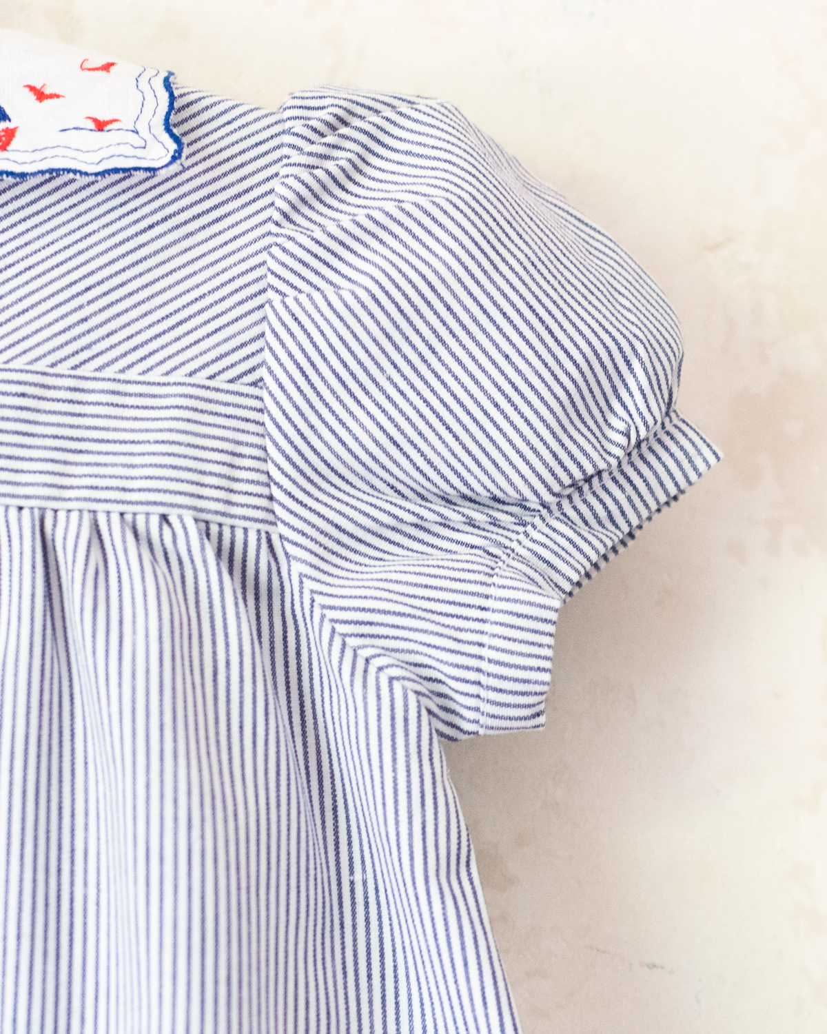 Striped dress with sailboats embroidered on the collar | 9-12 months