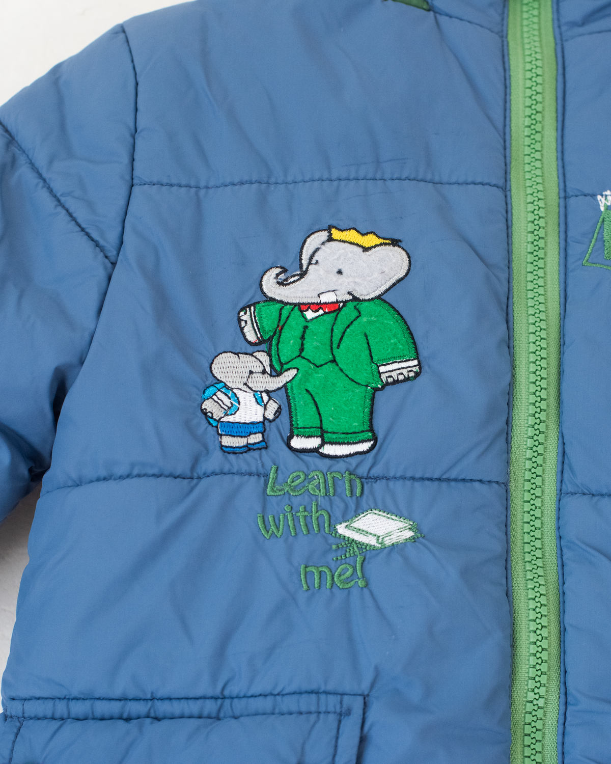 Blue fleece jacket with the king in the bar | 18-24 months