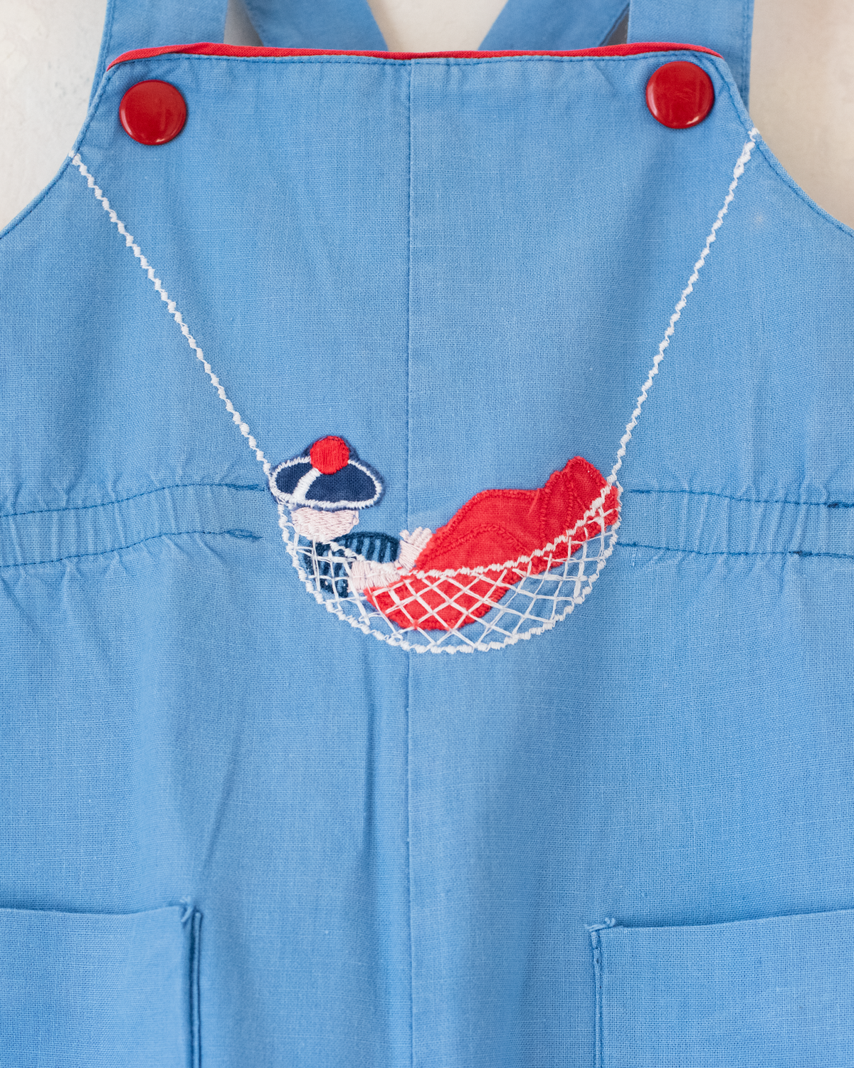 Light blue romper with a sailor on a swing | 12-18 months