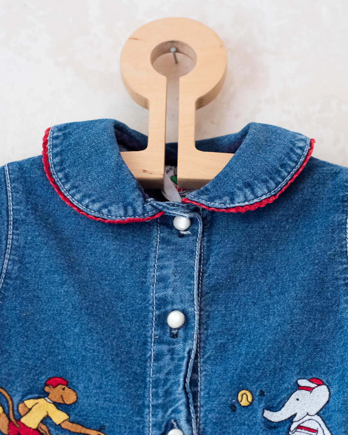 Denim dress with embroidery of the King of Bar and Zafir playing | 18-24 months
