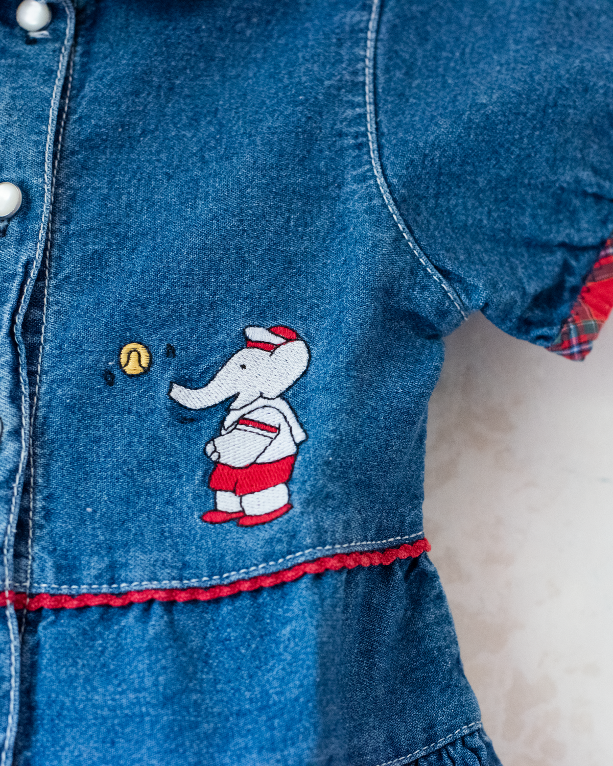 Denim dress with embroidery of the King of Bar and Zafir playing | 18-24 months