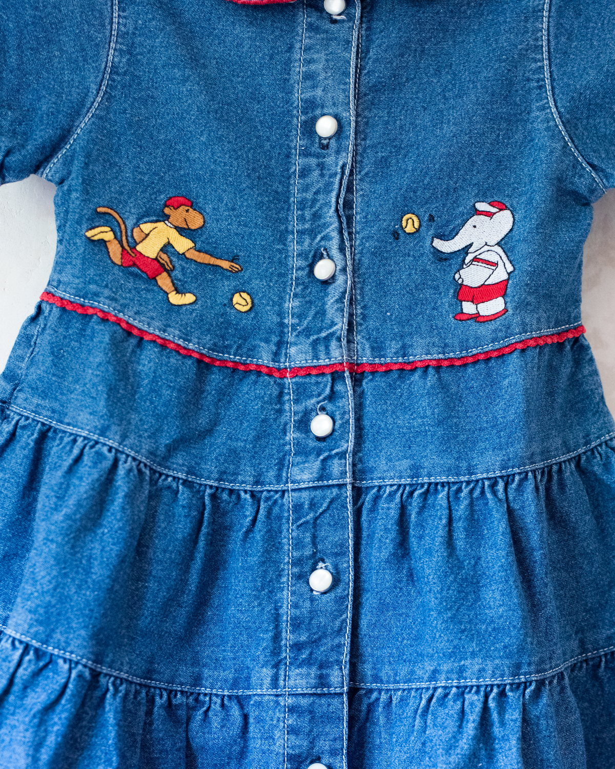 Denim dress with embroidery of the King of Bar and Zafir playing | 18-24 months