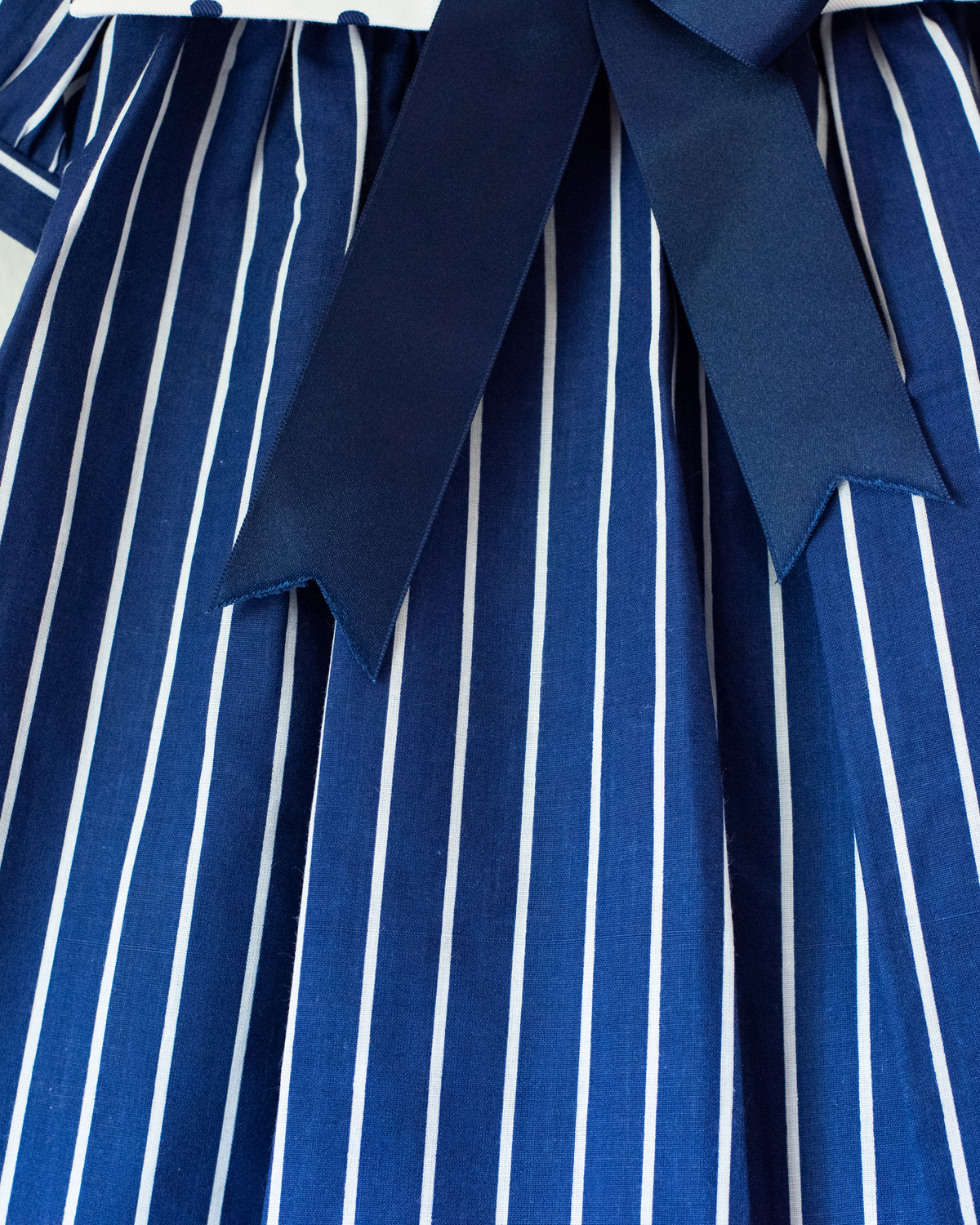 Blue dress with stripes, dots and a large bow tie | Spanish dead stock | 12-18 months