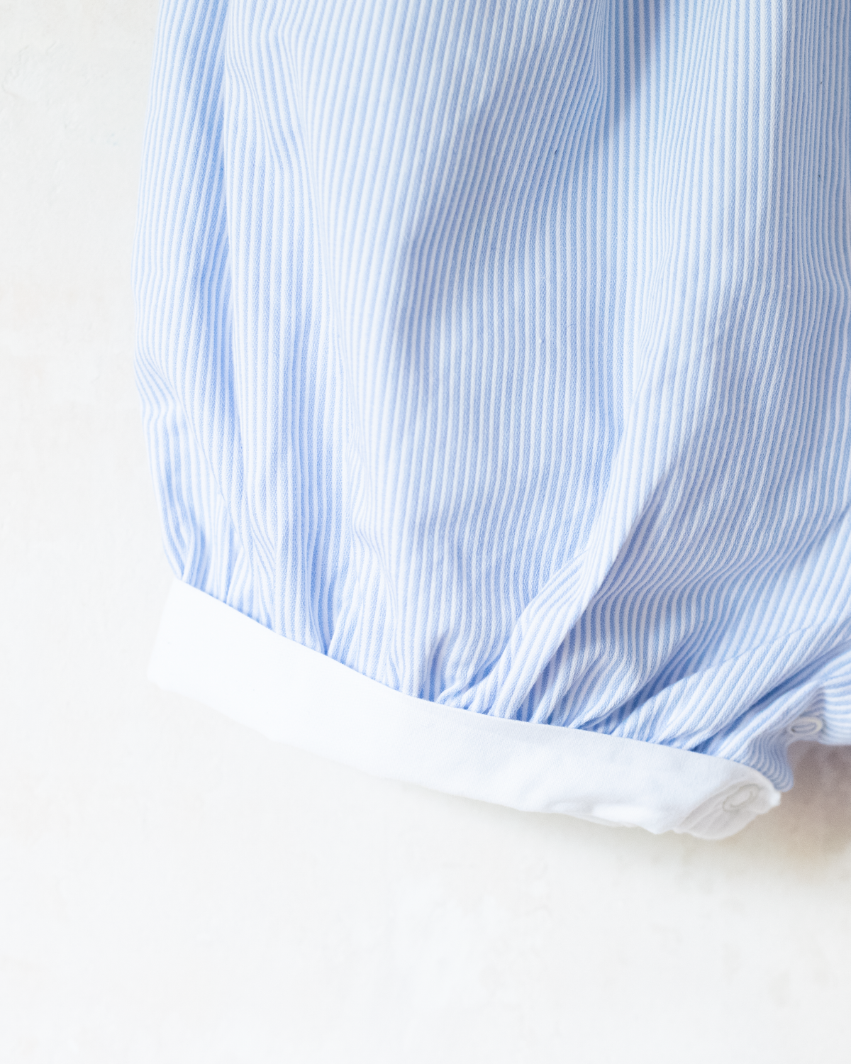Striped jumpsuit with embroidered comforter from Yves Saint Laurent | 9-12 months
