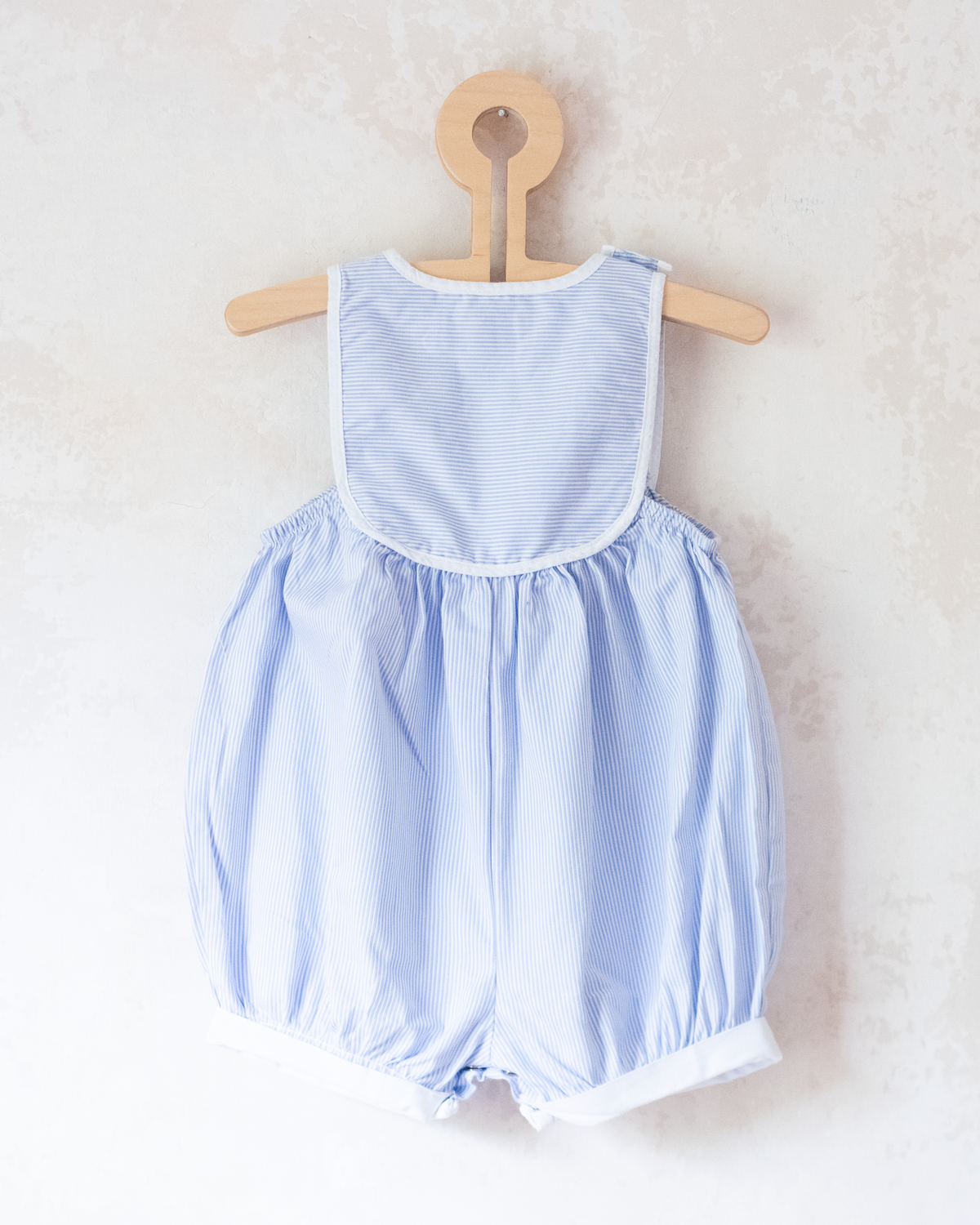 Striped jumpsuit with embroidered comforter from Yves Saint Laurent | 9-12 months