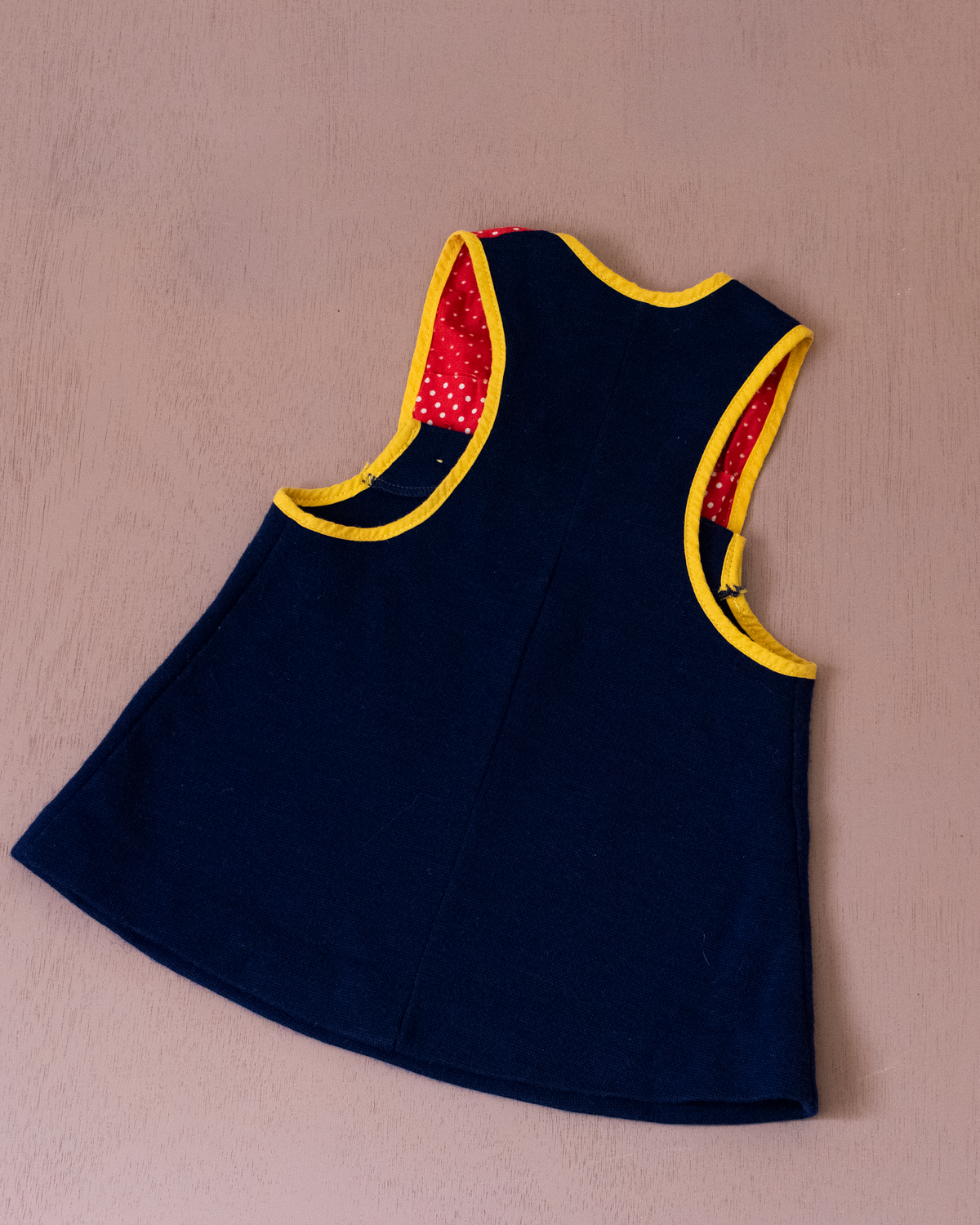 Blue pinafore with embroidered flower and polka dot pocket | 6-9 months