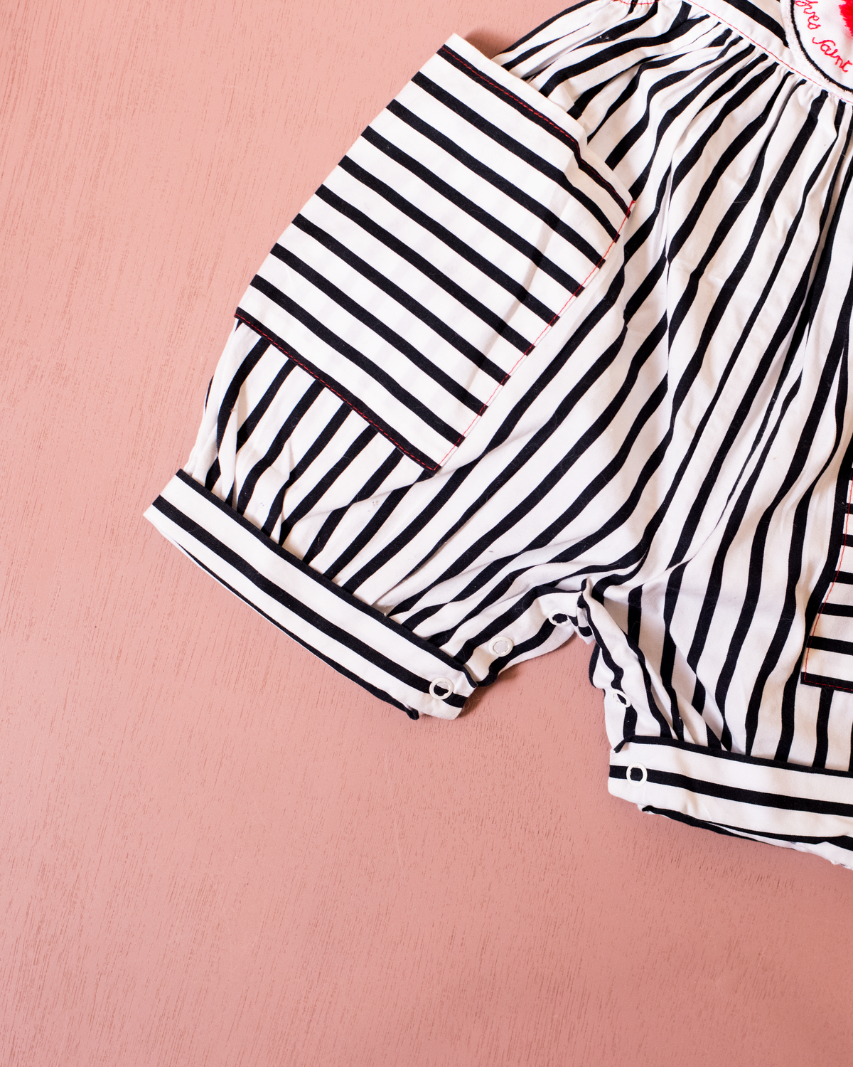Striped overalls and pom-poms from Yves Saint Laurent | 3-6 months