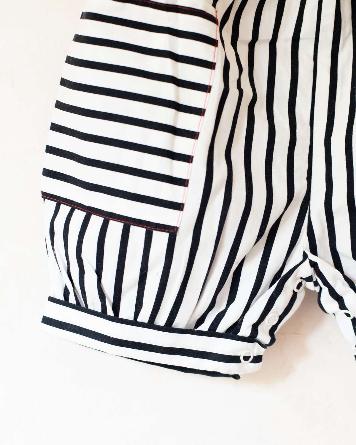 Striped overalls and pom-poms from Yves Saint Laurent | 3-6 months