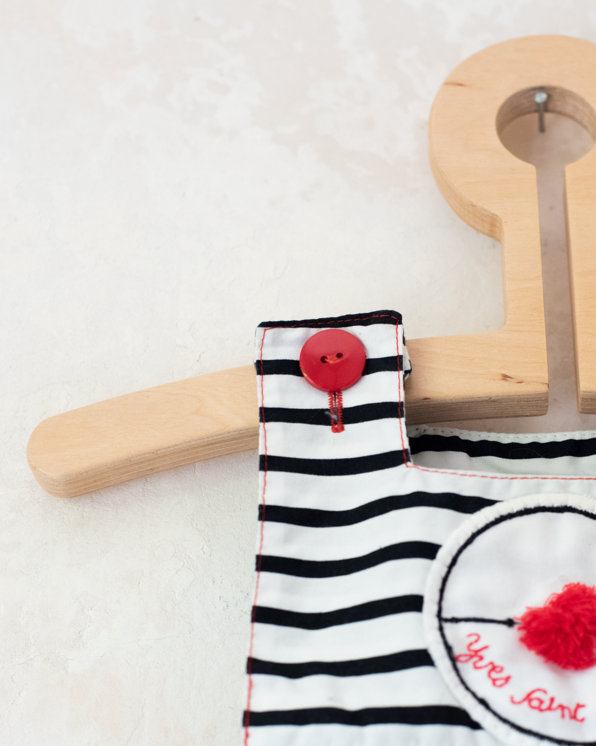 Striped overalls and pom-poms from Yves Saint Laurent | 3-6 months