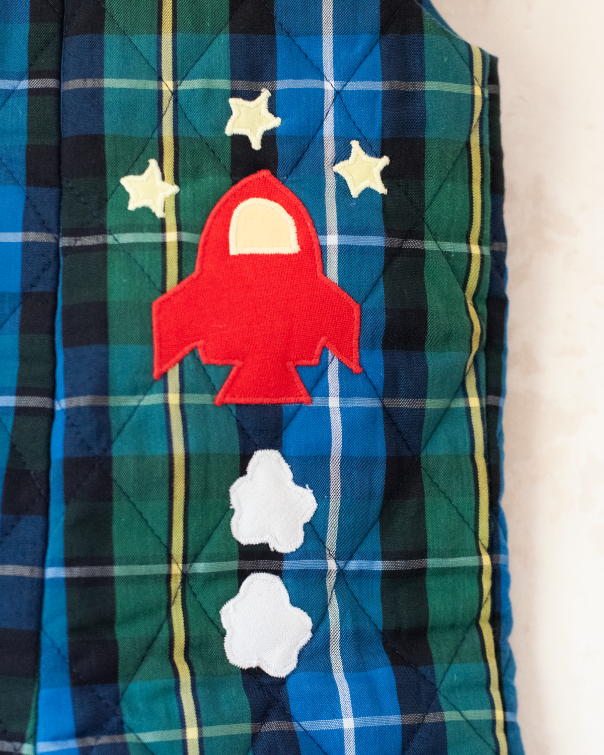 Green and blue plaid jumpsuit with spaceship embroidery | 9-12 months