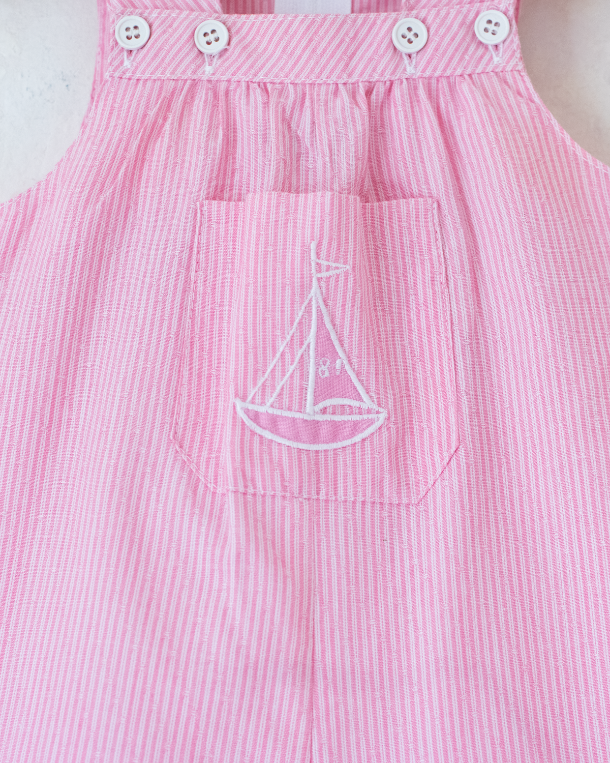 Pink striped overalls with embroidered sailboat | 6-9 months