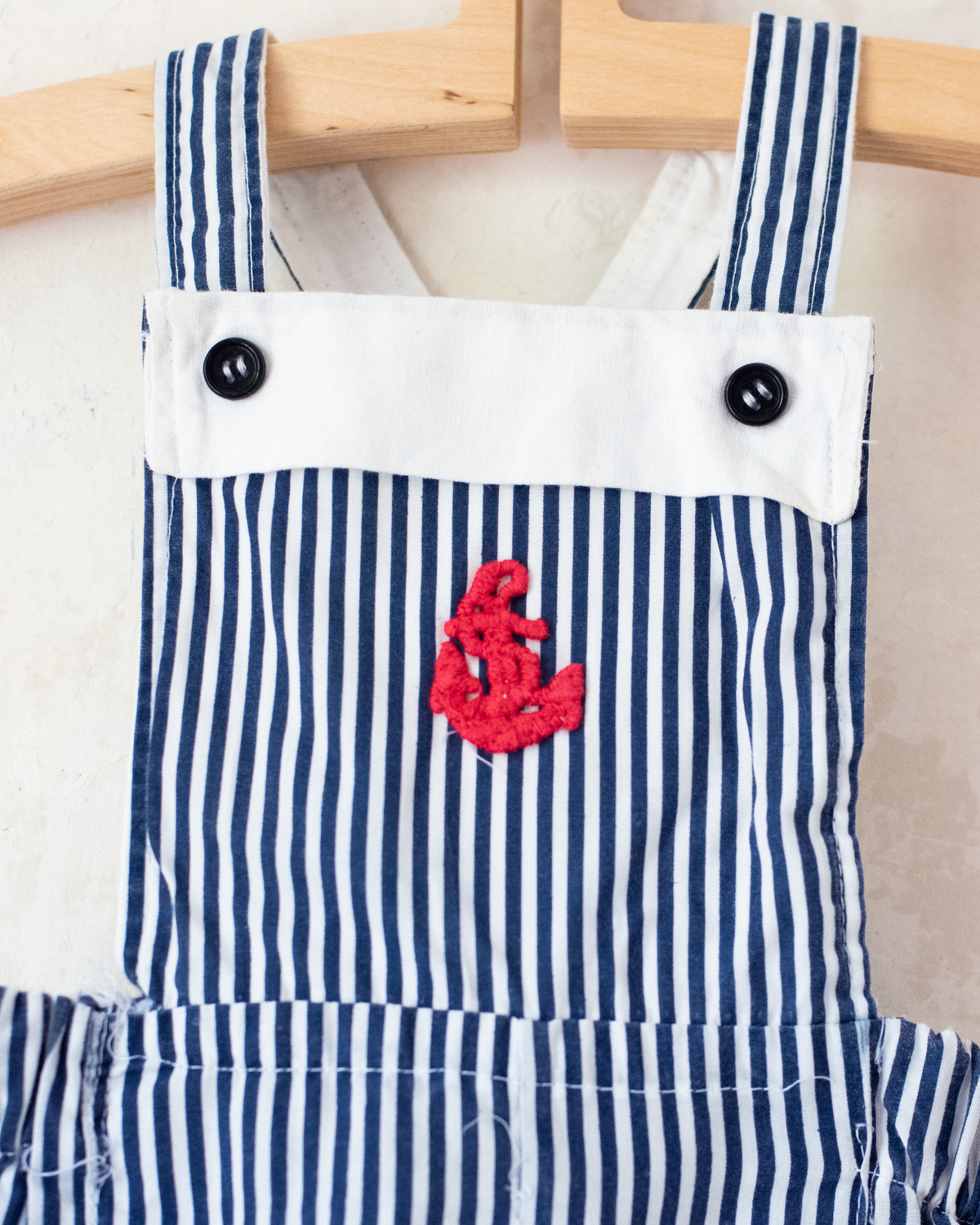 Striped overalls with embroidered red anchor | 12-18 months