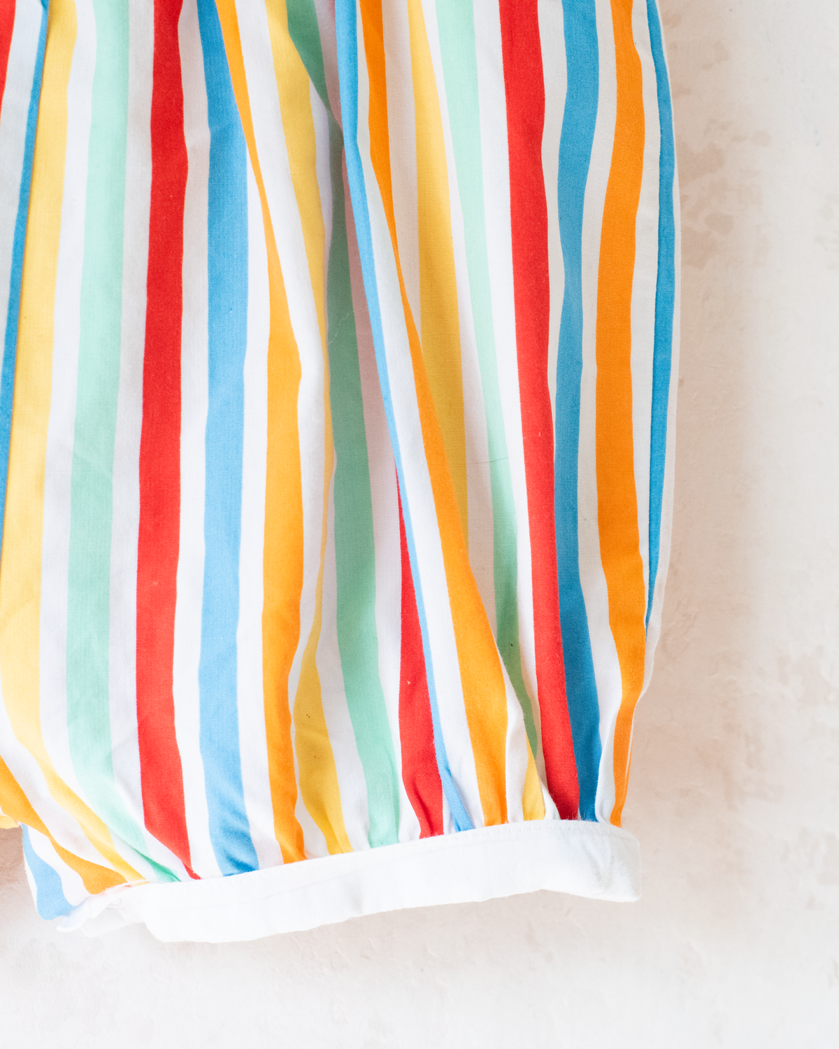 Colorful fruit-print jumpsuit by Yves Saint Laurent | 9-12 months