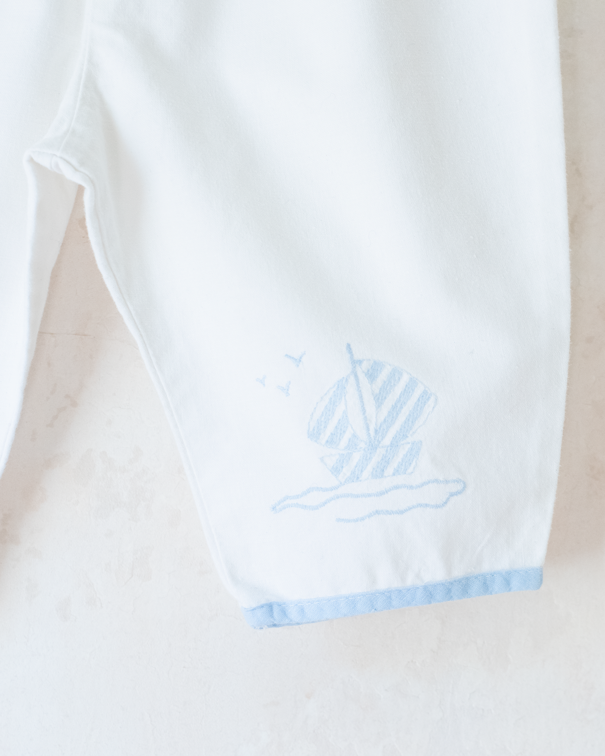 White sailor overalls with a boat embroidered on the leg | 9-12 months