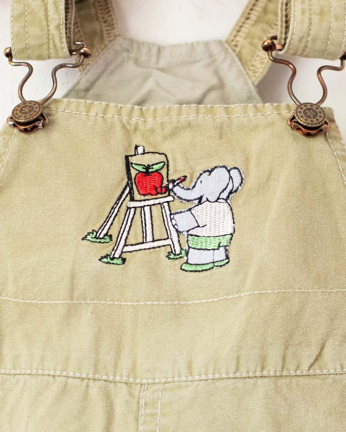 Olive-colored overalls with a Babar the King embroidery | 12-18 months