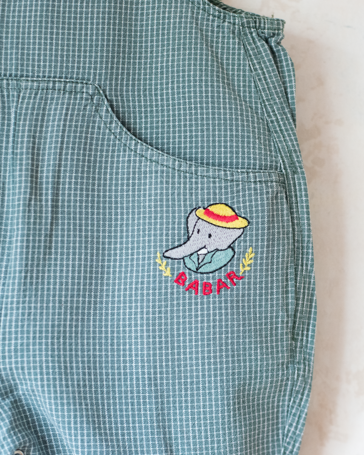 Green checkered romper with a Babar the Elephant embroidery | 12-18 months