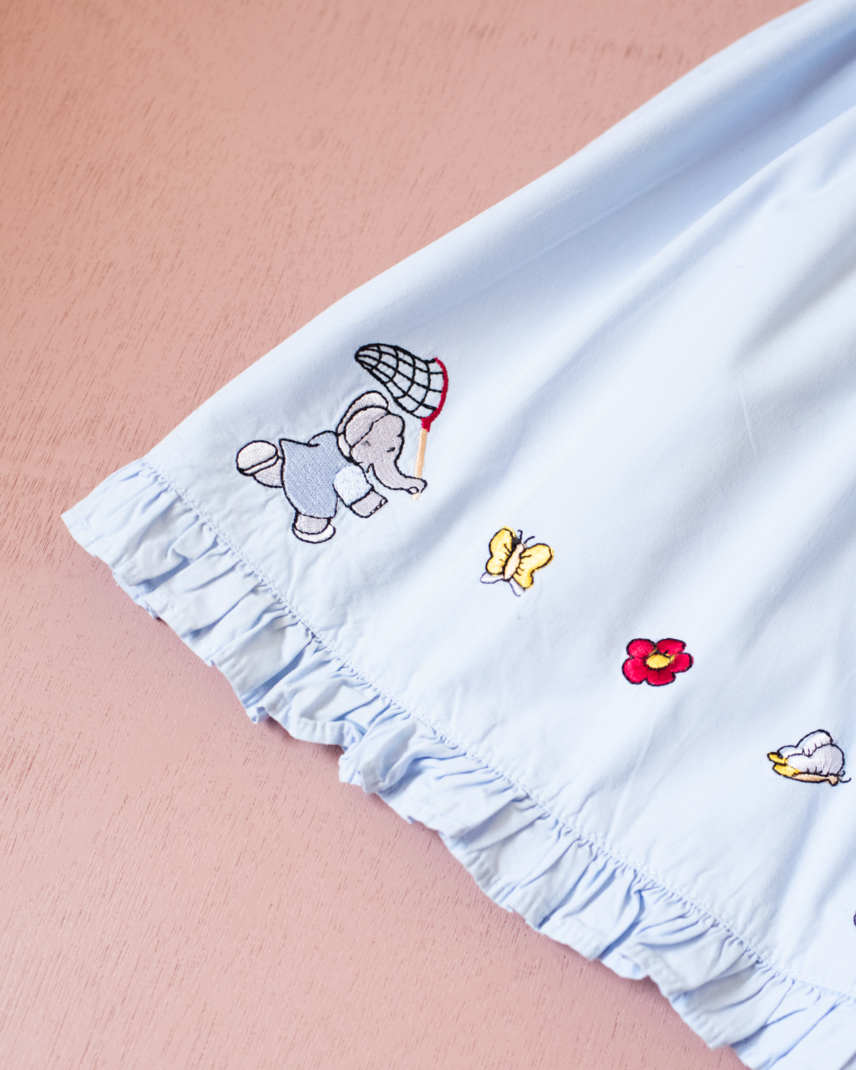 Light-blue dress with embroideries of King Babar and butterflies | 12-18 months