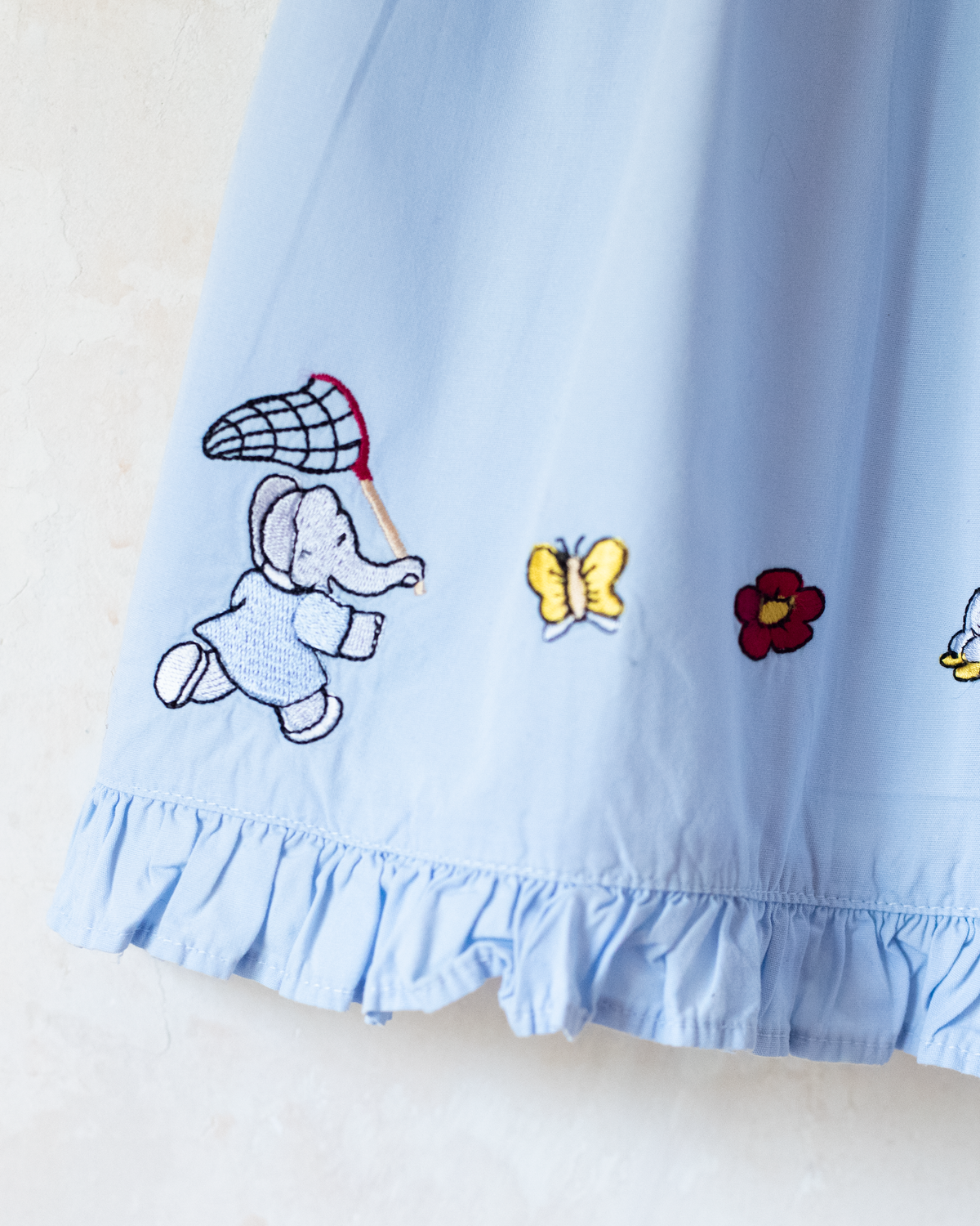 Light-blue dress with embroideries of King Babar and butterflies | 12-18 months