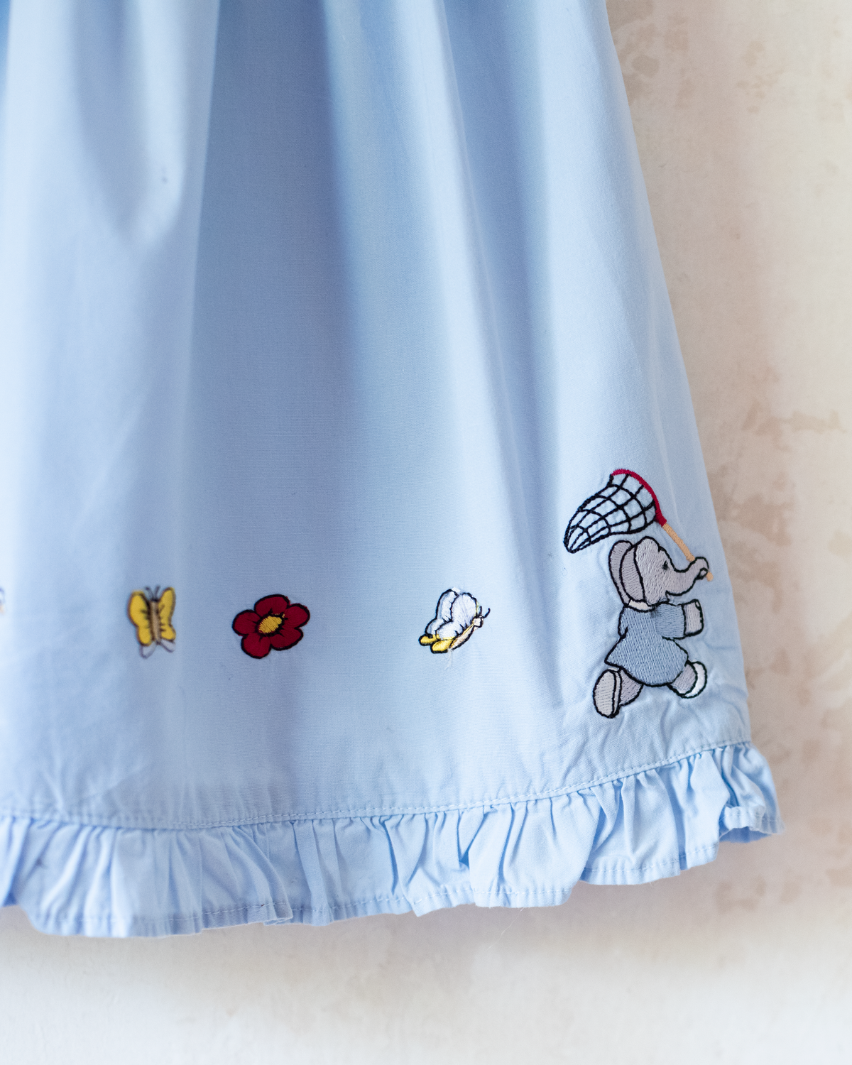 Light-blue dress with embroideries of King Babar and butterflies | 12-18 months