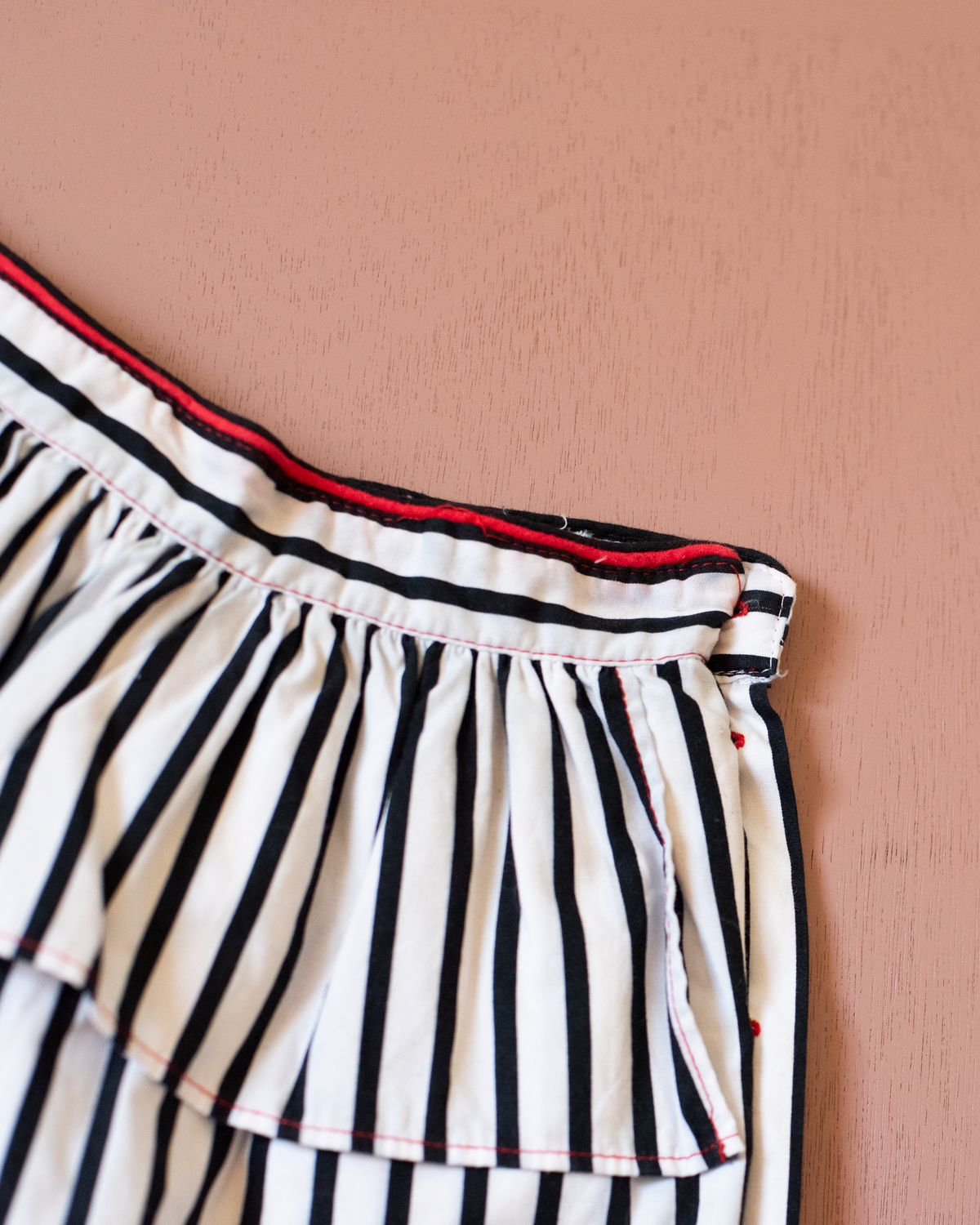 Striped skirt with a red pompom from Yves Saint Laurent | 3-4 years