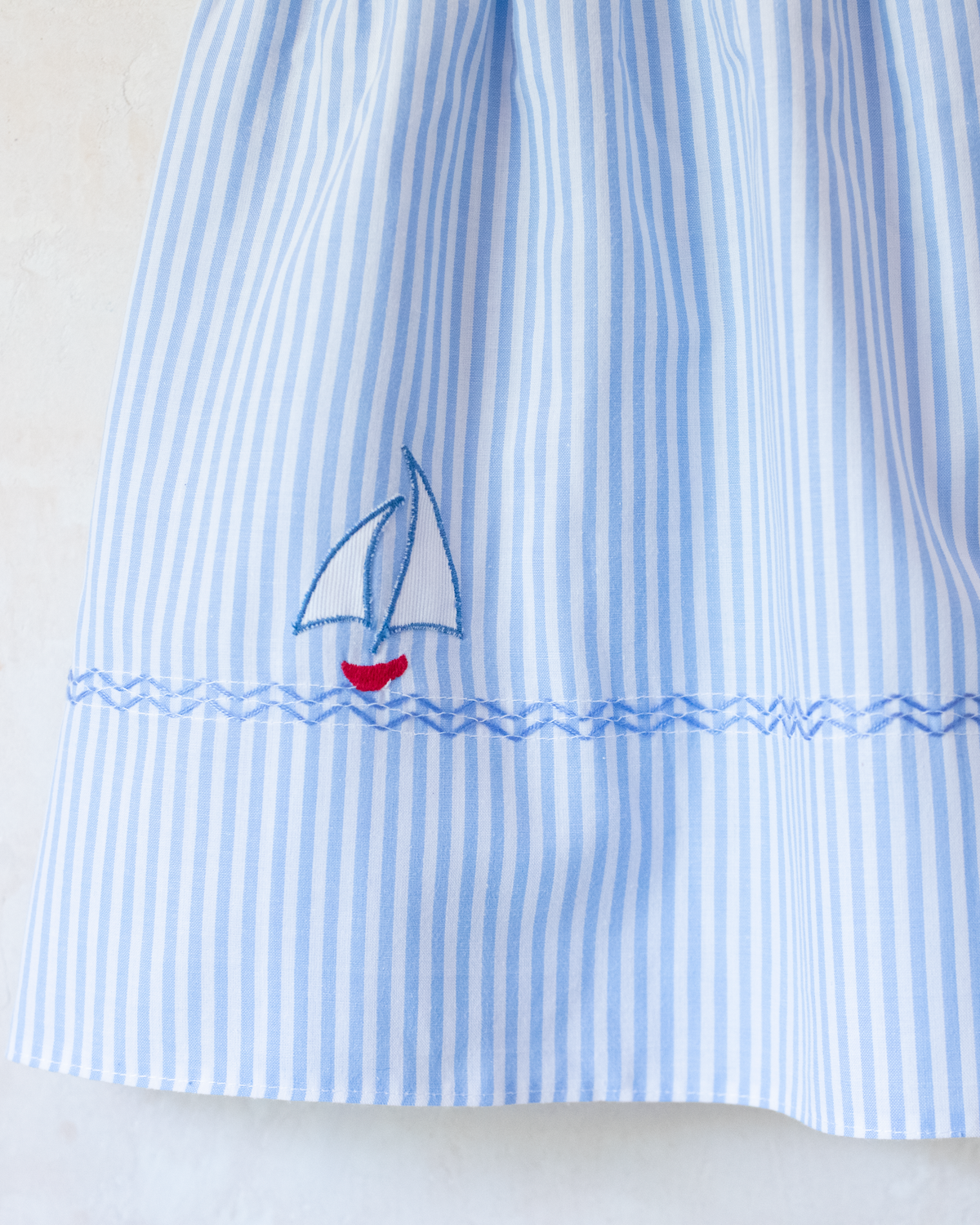 Striped dress with embroidered sailboat | 2-3 years